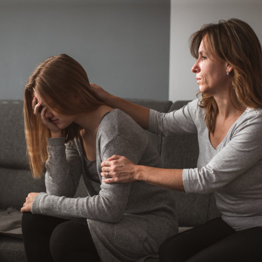 a woman comforting a sad woman