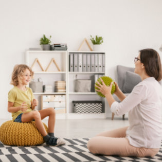 psychologist doing therapy with a kid