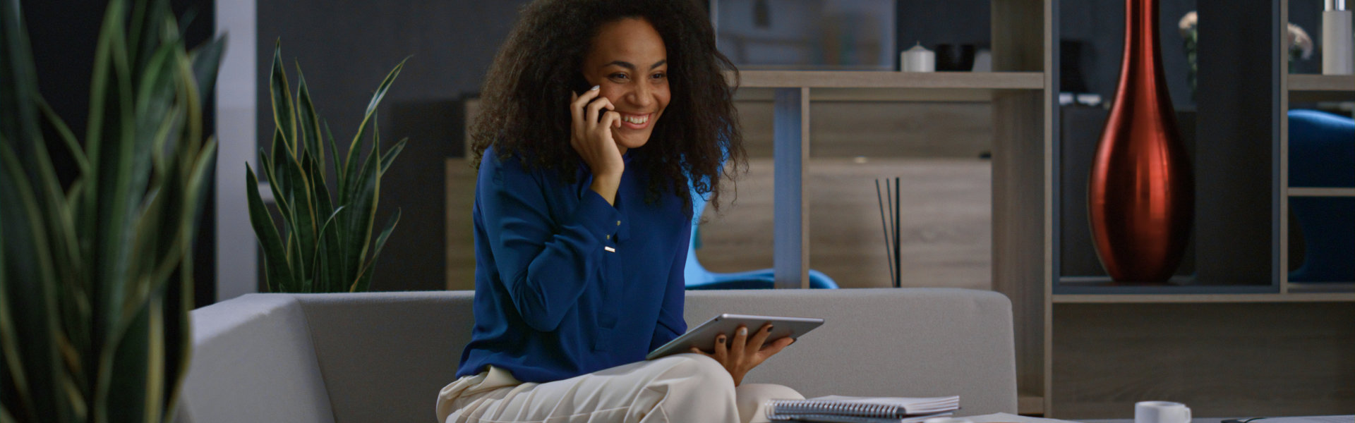 a woman smiling calling on her cellphone