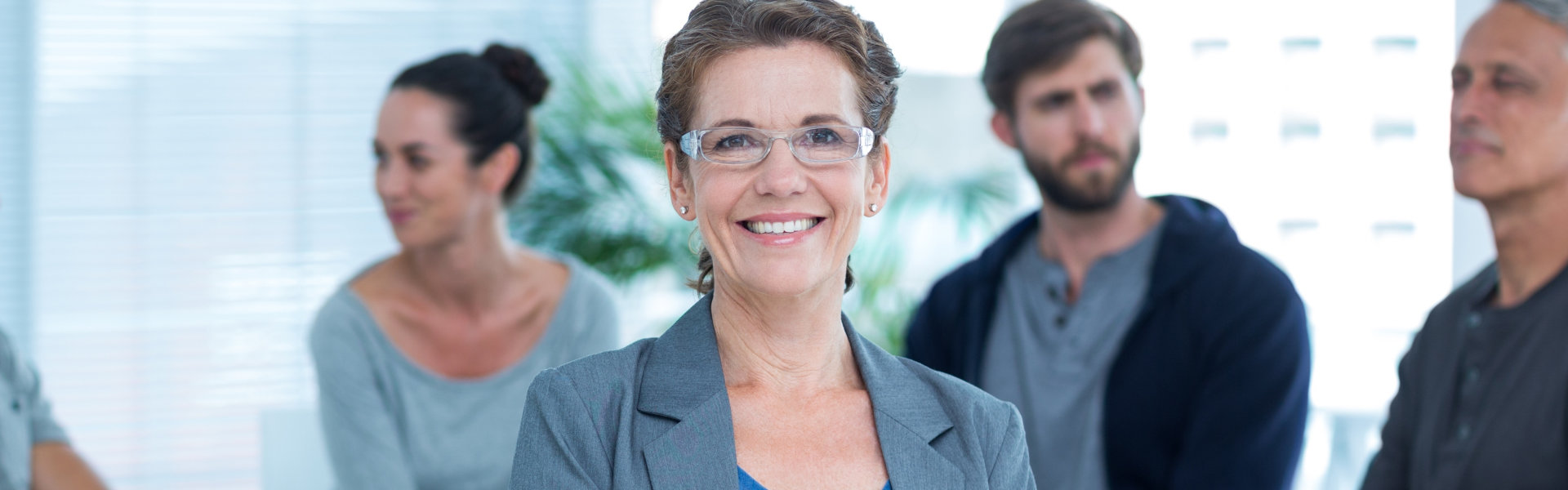 female psychologist smiling with people in the background